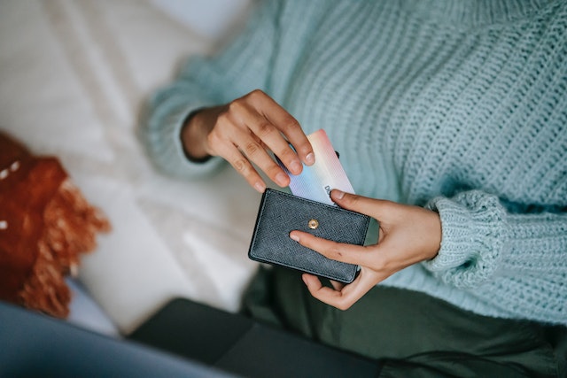 tenant-holding-credit-card-with-laptop-sitting-down-to-pay-rent